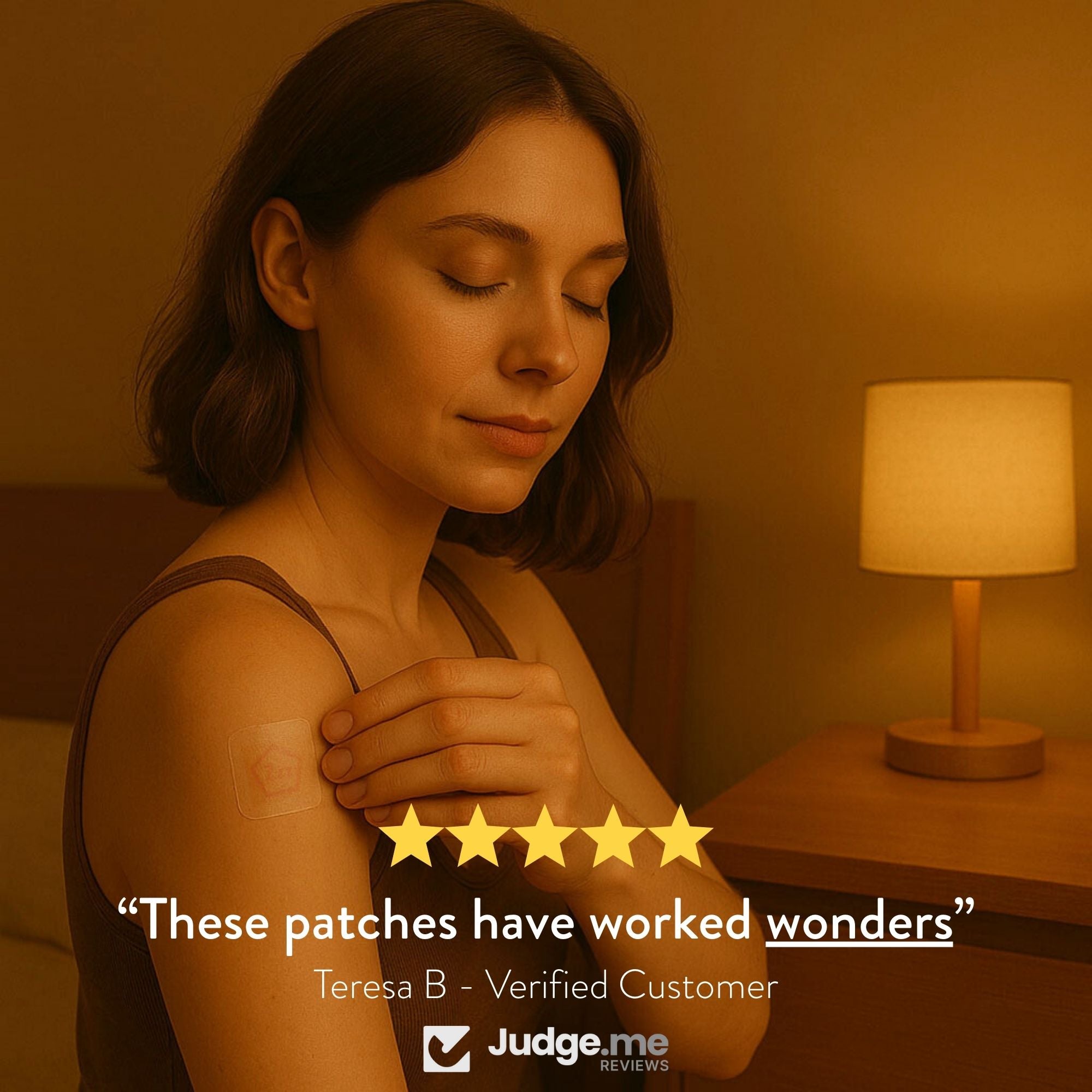 Woman with a sleep patch on her arm in a warm-toned room, with a lamp in the background.